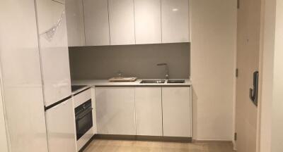 Modern white kitchen with cabinets, sink, and built-in appliances