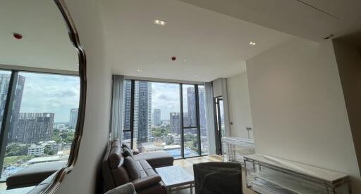 Modern living room with large windows and city view.