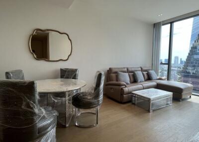 Modern living room with a large window view, dining area, and comfortable seating