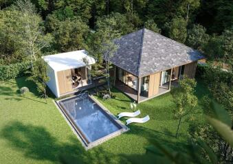 Aerial view of a modern house with a swimming pool and lawn