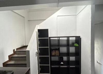 Living area with stairs and shelving