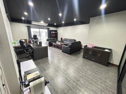 A spacious, well-lit living room with modern furniture