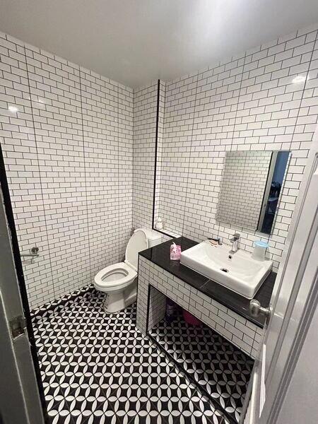 Modern bathroom with white subway tiles and patterned floor