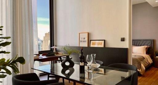 Modern living area with dining table and bedroom view