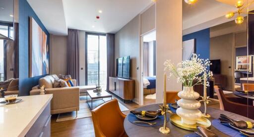 Modern main living area with open-plan design, featuring living room, dining area, and bedroom in view.