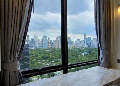 View from a window overlooking a city skyline and park