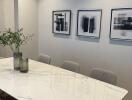 Contemporary dining area with marble table and modern art