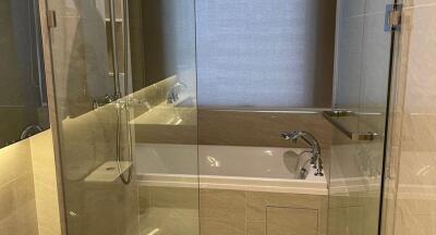 Modern bathroom with bathtub and glass shower enclosure