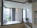 Modern bathroom with glass walls overlooking a city view