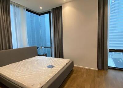 Modern bedroom with large windows and grey curtains