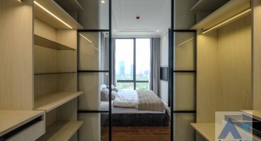 Modern bedroom with built-in closets and a large window