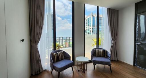 Living room with large windows and city view