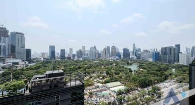 City skyline view from high-rise building with park and greenery