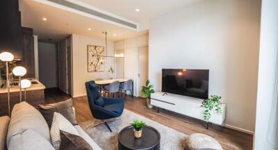 Modern living room with a cozy seating area, flat-screen TV, and stylish decor