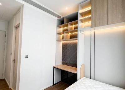 Modern bedroom with built-in shelves and desk