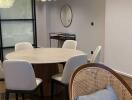 Modern dining area with round table and cushioned chairs