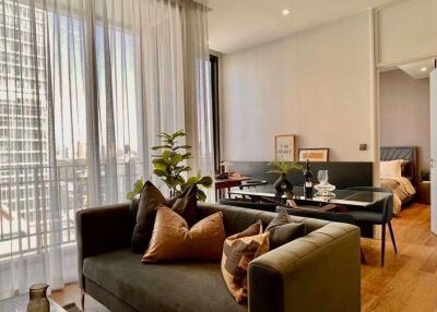 Modern living room with a view of a bedroom through an open door