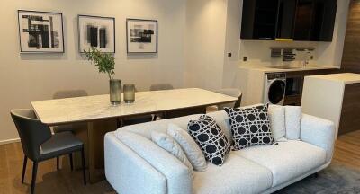 Modern living area with a white sofa and artwork on the wall