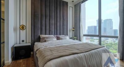 Modern bedroom with large window and city view