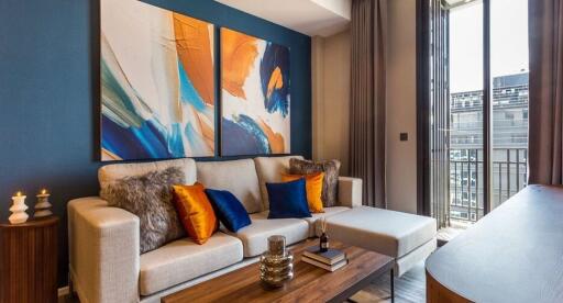 Modern living room with colorful abstract paintings and cozy seating