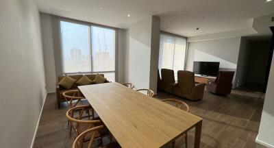 Modern living and dining area with large windows