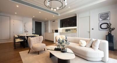 Modern living room with a kitchen and dining area.