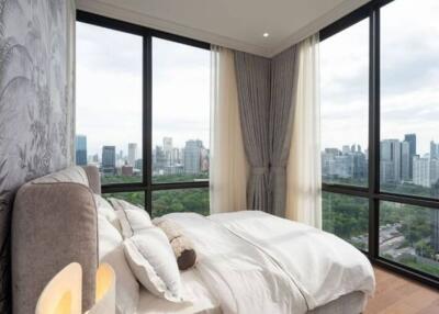 Modern bedroom with large windows and city view