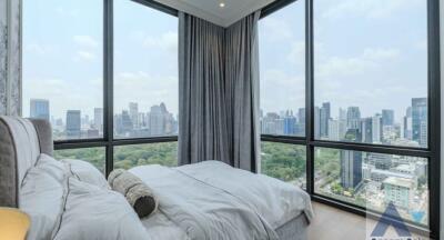 A modern bedroom with a panoramic city view