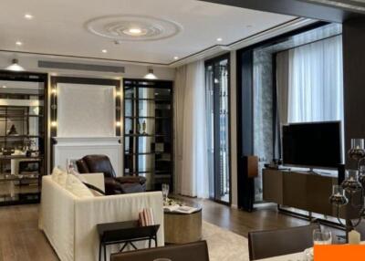Modern living room with a seating area, TV, and elegant furnishings
