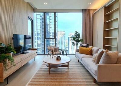 Modern living room with a large window, sofa, TV, coffee table, and shelving