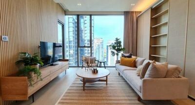 Modern living room with a large window, sofa, TV, coffee table, and shelving