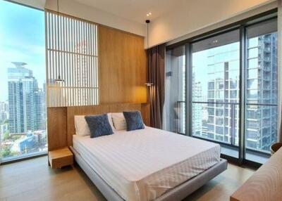 Modern bedroom with large windows and city views