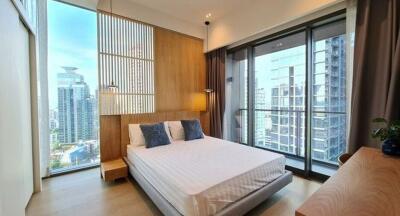 Modern bedroom with large windows and city views