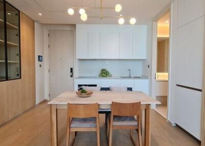 Modern kitchen and dining area with wooden elements and built-in shelving