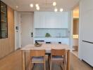 Modern kitchen and dining area with wooden elements and built-in shelving