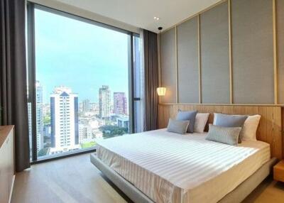 Modern bedroom with large window and city view