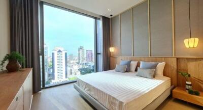 Modern bedroom with large window and city view