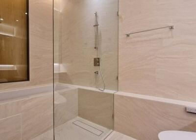 Modern bathroom with glass shower enclosure and elegant tile design