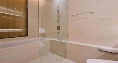 Modern bathroom with glass shower enclosure and elegant tile design