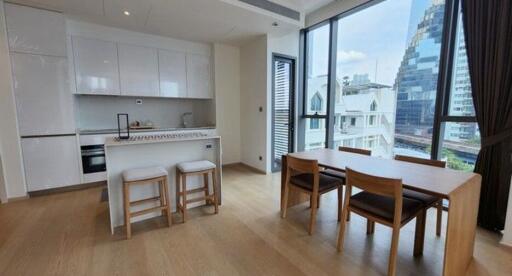 Modern kitchen and dining area with large windows and city view