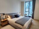 Modern bedroom with double bed and city view