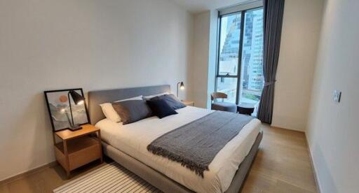 Modern bedroom with double bed and city view