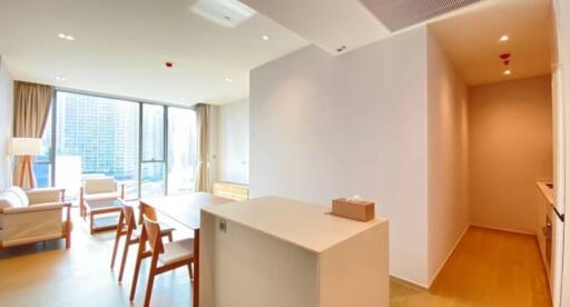 Modern living room with dining area and natural light