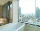 Bathroom with large window and city view