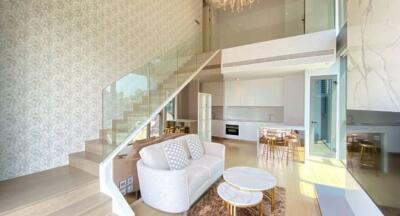 Modern living room with high ceiling and mezzanine.