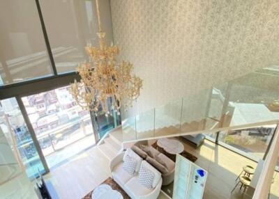 Modern living room with large windows and chandelier