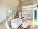 Modern duplex living area with white sofa, glass railing staircase, chandelier, and open kitchen