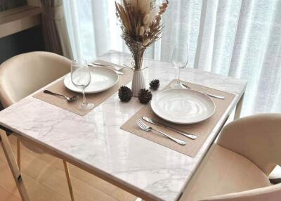 A cozy dining area with a marble table set for two