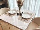 A cozy dining area with a marble table set for two