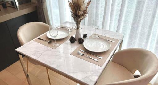 A cozy dining area with a marble table set for two